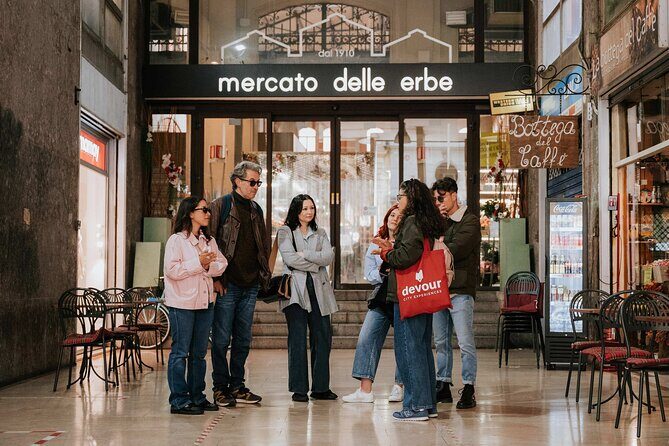 Devour Bologna Tastes & Traditions Food Tour with Market Visit - Mercato delle Erbe: cheese stalls, balsamic parmigiana, and mortadella panini